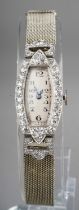 A ladies Art Deco diamond set cocktail watch, the shaped rectangular dial with Arabic numerals,