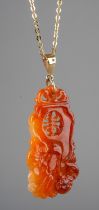 A Chinese carved pendant, the shaped rectangular panel carved and pierced, approx 4.8cm long, on 9ct