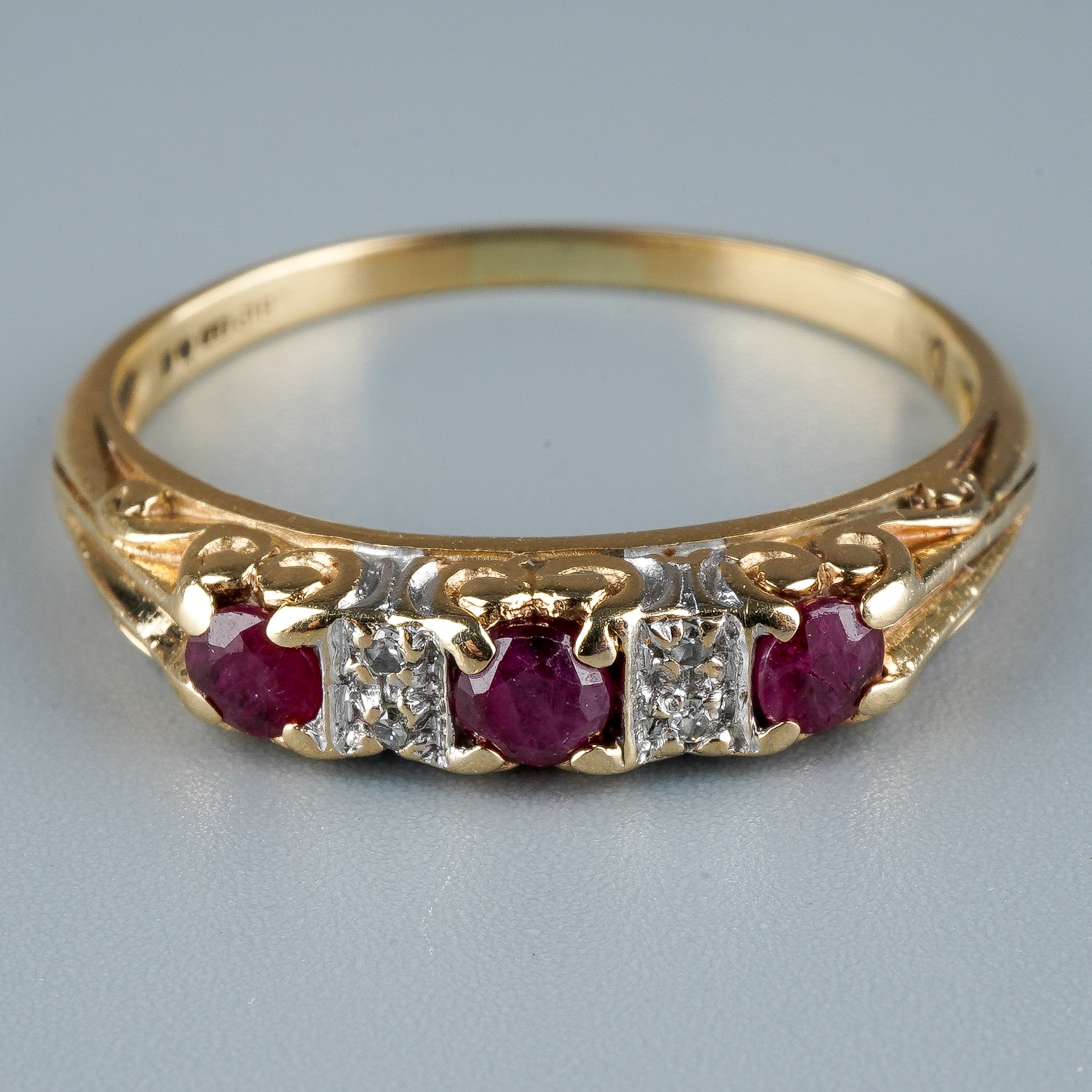 A 9ct yellow gold ruby and diamond ring, set with three round-cut rubies with diamond-chip - Image 2 of 6