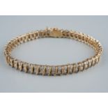 A 9ct gold and diamond line bracelet, with two round brilliant-cut diamond set links between S