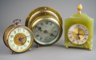 A vintage brass mounted ship's (bulkhead) clock with silvered dial together with an early 20th