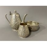 Late 19th century Indian Kutch silver three-piece tea set. The tea pot and jug have handles in the