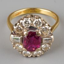 An 18ct yellow gold ruby and diamond cluster ring, set with an oval-cut ruby within a border of