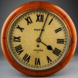 Wall Clock by Potts of Leeds in a wooden mahogany case, with Roman numerals on the dial.