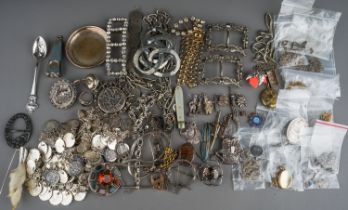 A collection of silver and white metal jewellery, including chains, watch chains, brooches,