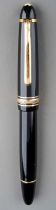 A Montblanc Meisterstuck black fountain pen with gilt fittings, the 14K white and yellow gold nib