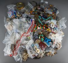 A large quantity of costume jewellery, including brooches, beads, chains, earrings, pendants, etc