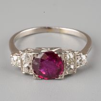 An Art Deco style ruby and diamond ring, set with a round-cut ruby flanked by six old-cut