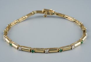 A 14ct gold emerald and diamond bracelet, each rectangular link alternatively divided by a diamond