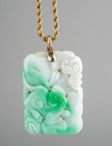 A Chinese carved jade pendant, on a 9ct gold rope twist chain, total gross weight approx 32.5g (gold