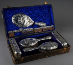 A matched Edwardian silver mounted dressing table service to include: a pair of hair brushes, a pair