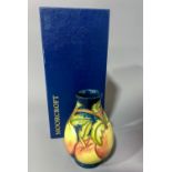 Moorcroft pomegranate pattern vase in a box, marked and signed to base In good overall condition