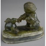 A nephrite coloured carved figure of boy holding a rabbits on an oval plinth base damage to larger