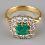 An emerald and diamond square cluster ring, set with a square-cut emerald surrounded by twelve round