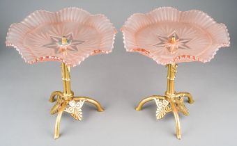 A pair of Art Nouveau style brass and opaline glass comports, pink wavy glass above cast stands with