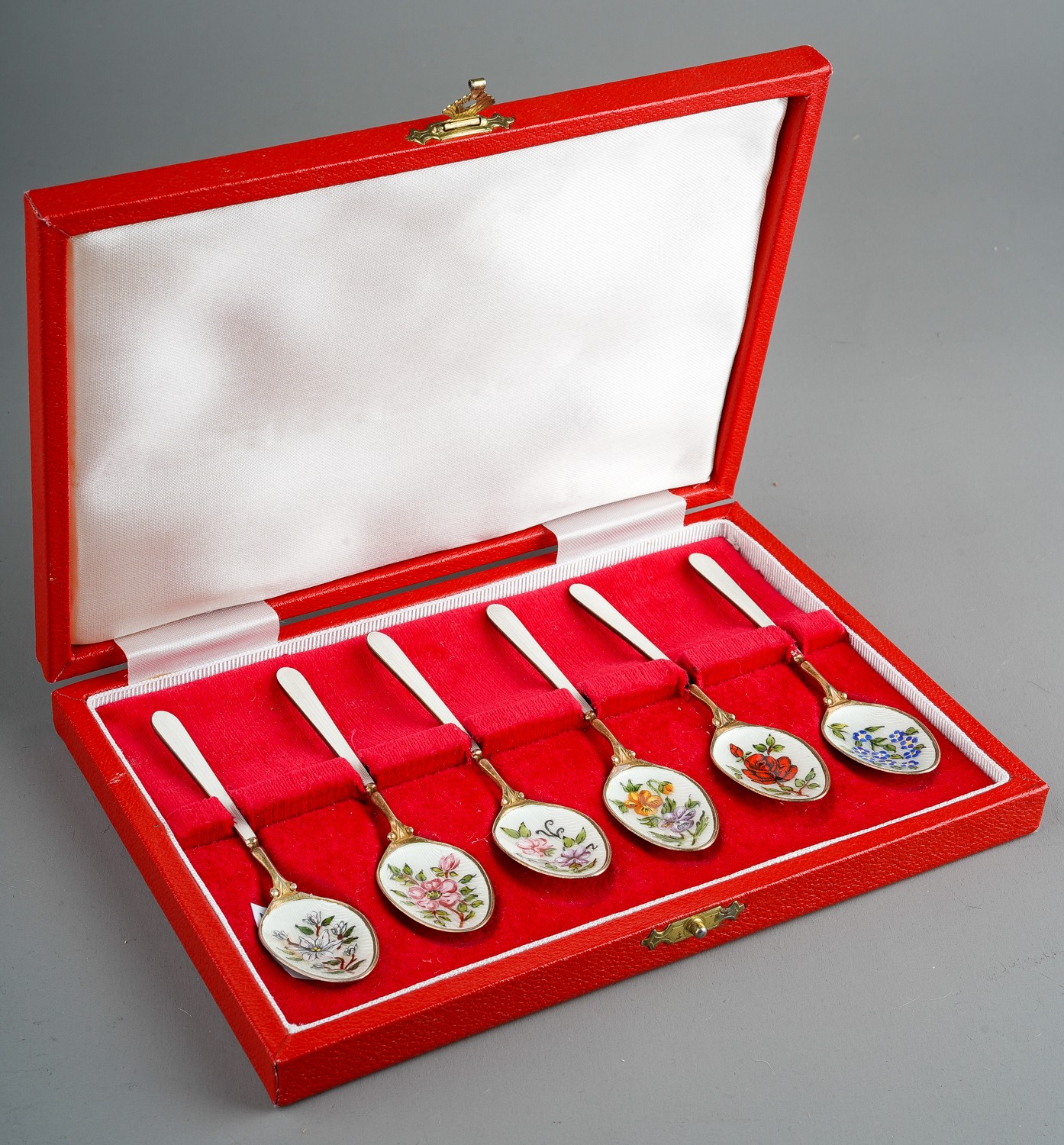 A set of six Modern silver gilt and enamel teaspoons, the bowls decorated with flowers, roses,