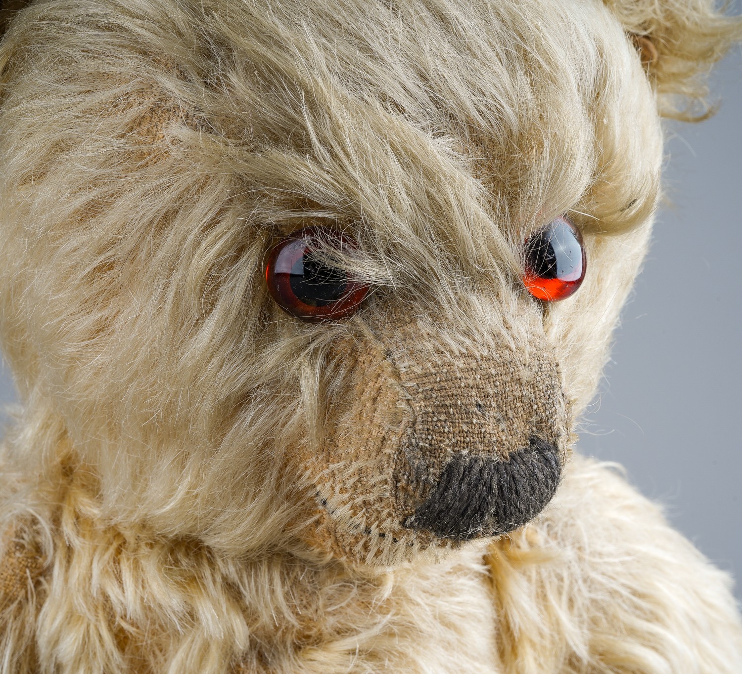 A 1930's Merrythought teddy bear, with blonde mohair, one orange and black glass eyes, black - Image 5 of 5