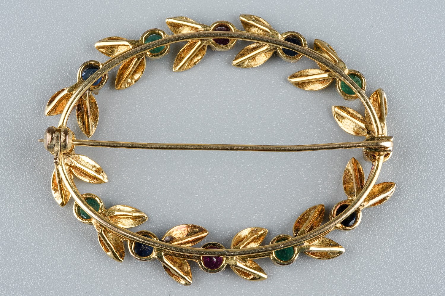 A yellow gold and gem-set oval brooch, set with rubies, emeralds and sapphires, approx 4.5cm wide, - Image 3 of 3