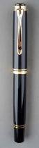 A Pelikan Souveran black and gilt fountain pen, the nib stamped 18C-750 M with logo, the cover