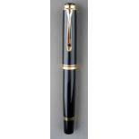 A Pelikan Souveran black and gilt fountain pen, the nib stamped 18C-750 M with logo, the cover