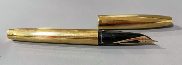 A Sheaffer gold plated fountain pen, the nib stamped SHEAFFER 14K R 585 USA, the cover stamped