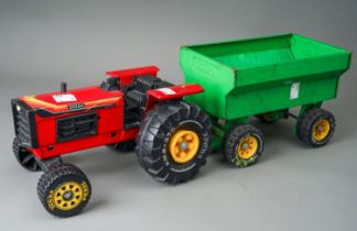 Tonka Toys. A red farm tractor missing steering wheel with accompanying green trailer. Large