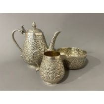 Late 19th century Indian Kutch silver three-piece tea set. The tea pot and jug have handles in the