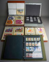 A collection of approximately 440 Royal Mail stamp issue postcards presented in three purposed