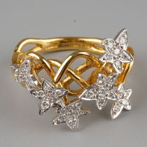An 18ct gold and diamond dress ring, the intertwined shank applied with six stars set with round