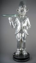 A floor standing silvered figure of dressed monkey with glass bowl in right hand (Butler tray), 82cm