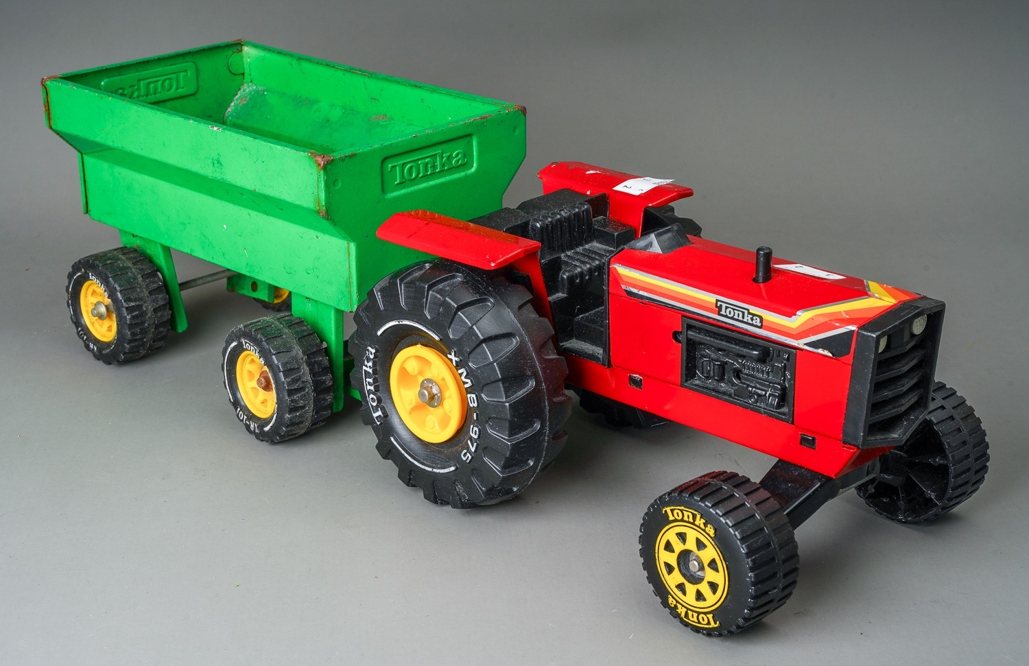 Tonka Toys. A red farm tractor missing steering wheel with accompanying green trailer. Large - Image 3 of 3