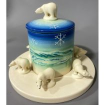 A Dennis China Works preserve pot and stand, cylindrical jar and cover with polar bear finial, the