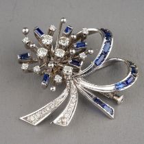 A 14k white gold diamond and sapphire brooch, set with round-cut diamonds and calibre-cut sapphires,