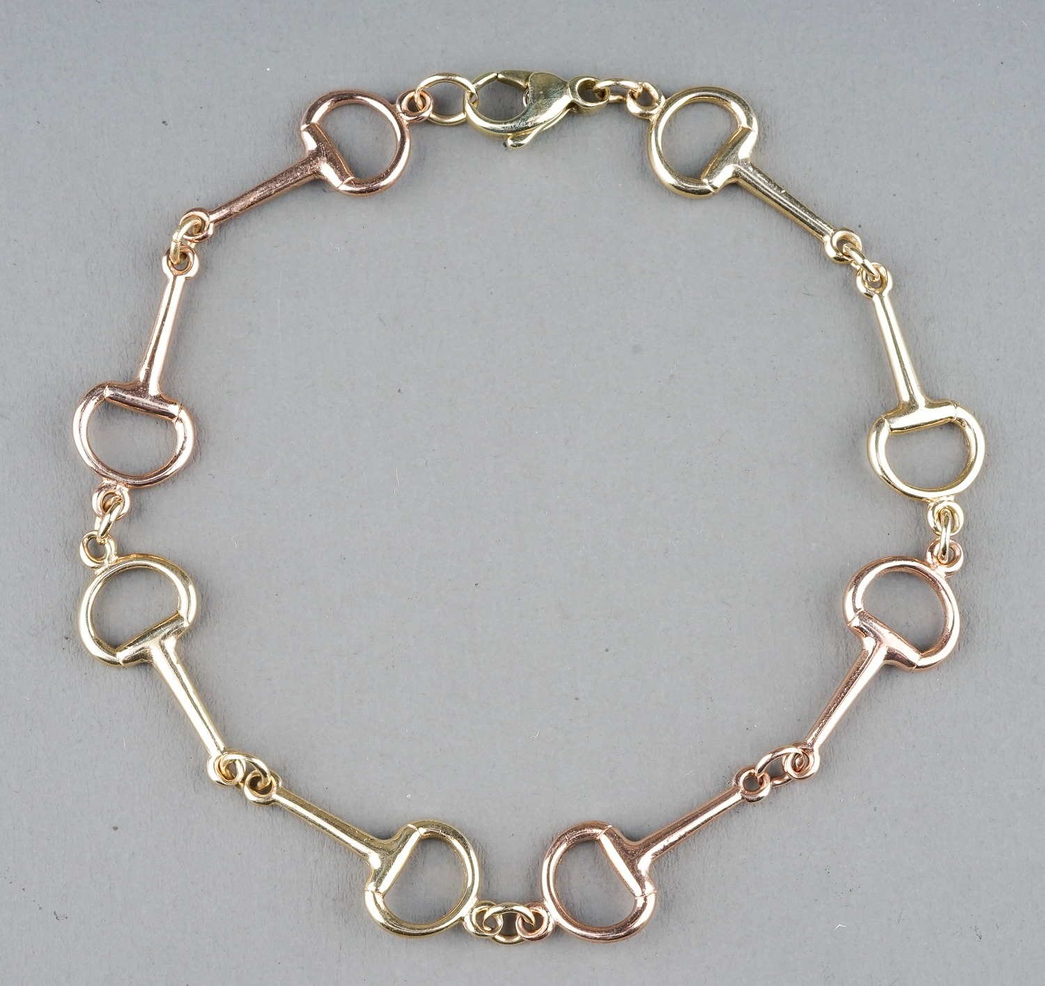 A 9ct yellow and rose gold snaffle bit bracelet, approx 20cm long, gross weight approx 6.2g