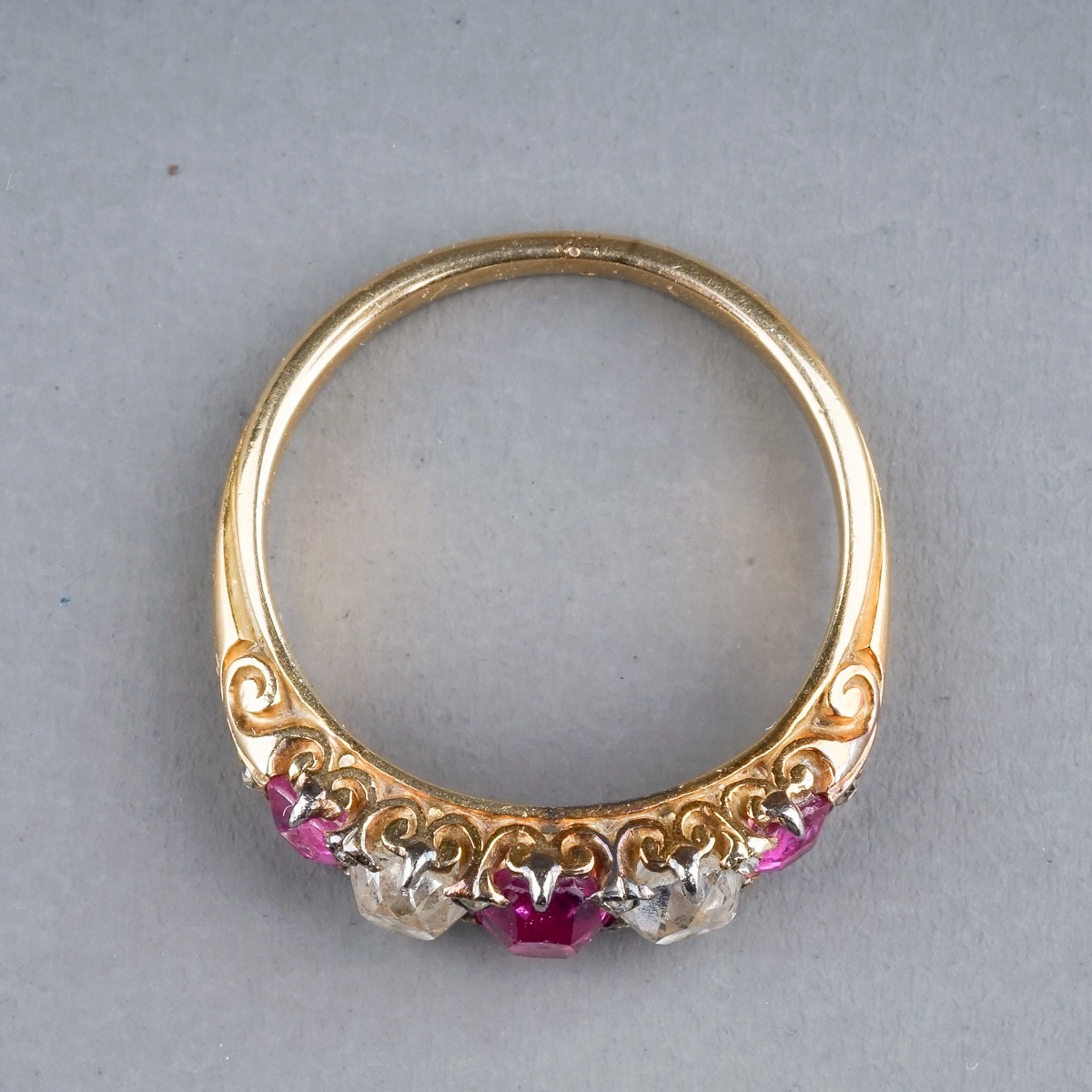 A yellow gold ruby and diamond five-stone ring, set with three graduated rubies and two old-cut - Image 4 of 5