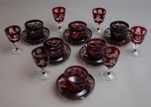 A set of six Bohemian ruby glass teacups and saucers together with a set of six ruby flash glass