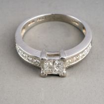 A platinum and diamond ring, set with four princess-cut diamonds in a square settings, set with