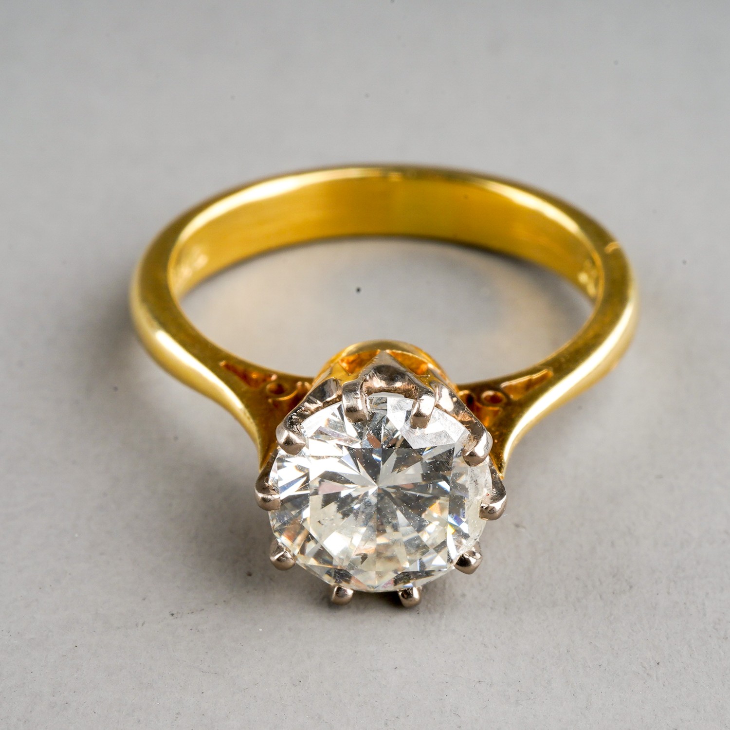 An 18ct yellow gold and diamond solitaire ring, the round brilliant-cut diamond approx 1.5cts,