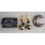A 19th Century tortoiseshell and gold pique brooch, the crescent shaped brooch set with scroll and