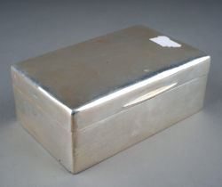 A George V silver cigarette box, of plain rectangular form, 14cm wide, London 1931, cedar lined
