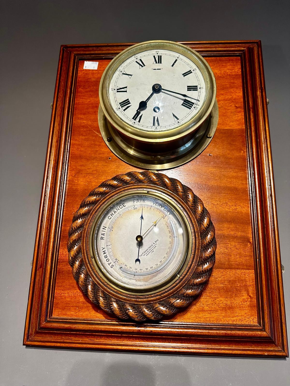 A mounted brass Ship's clock and wooden mounted barometer together with a Modern brass and green