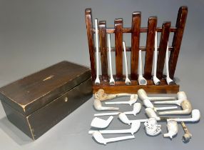 A collection of clay pipes with a money box and stand (1 box)