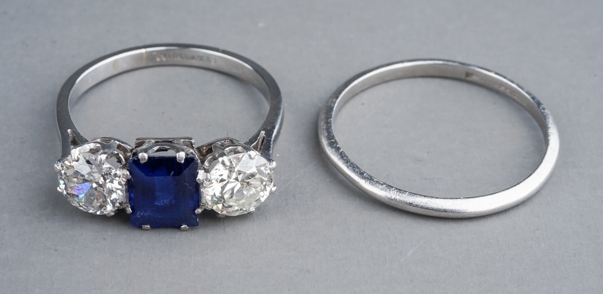 An early 20th century platinum diamond and sapphire three-stone ring, the rectangular-cut sapphire