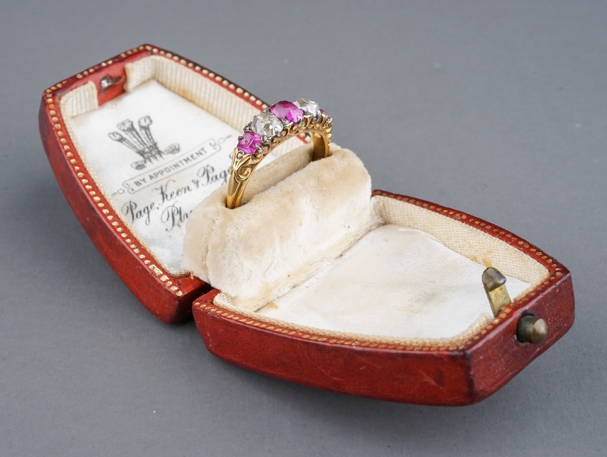 A yellow gold ruby and diamond five-stone ring, set with three graduated rubies and two old-cut - Image 2 of 5