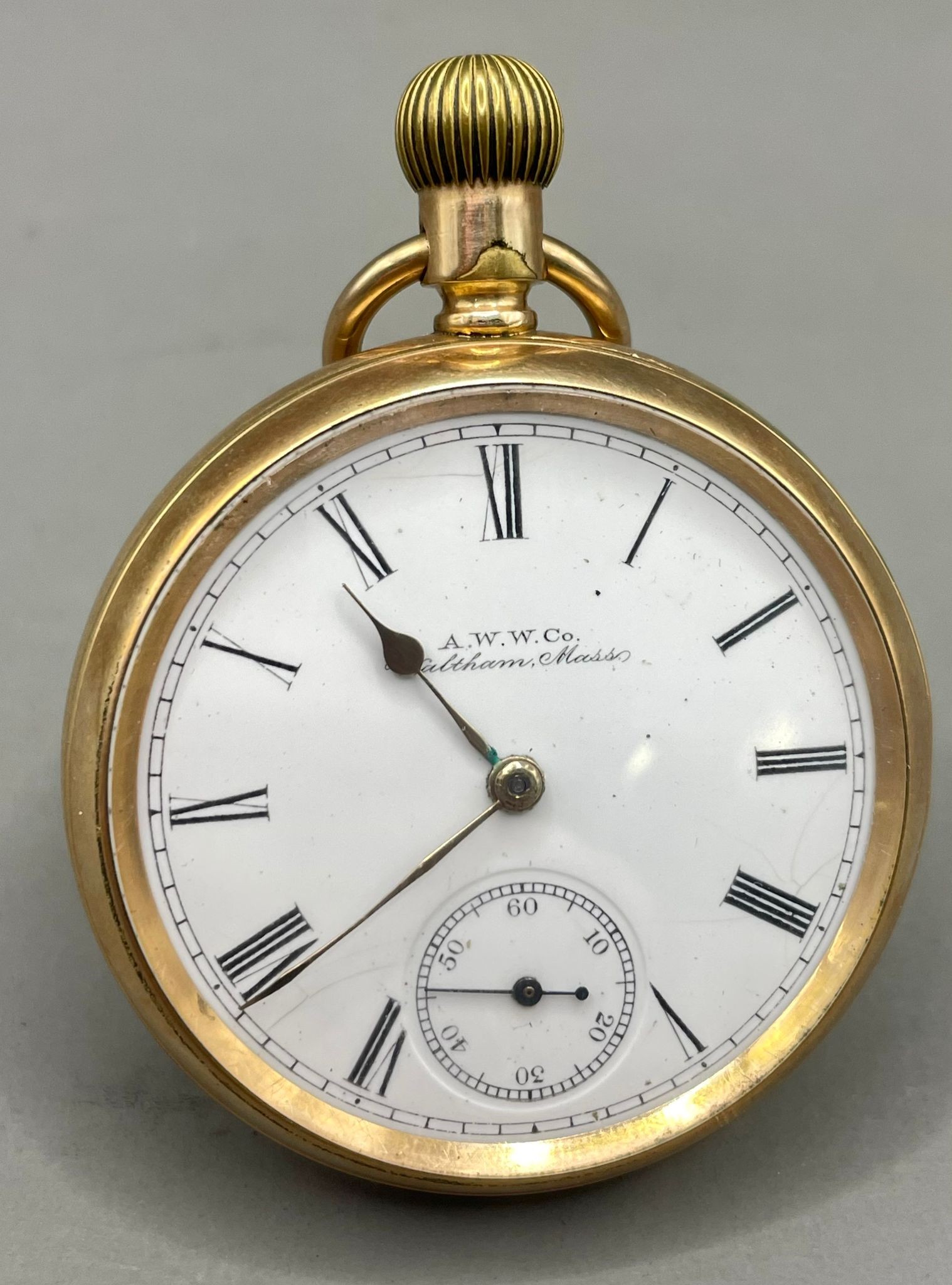 An A.W.W.Co Waltham 14ct gold plated openface pocket watch, 43mm white enamel dial with black