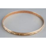 A 9ct yellow gold bangle, chased with foliate design, internal diam approx 6.5cm, gross weight