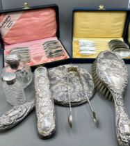 An Edwardian silver backed dressing table brush, comb (missing bristles) and mirror, embossed with