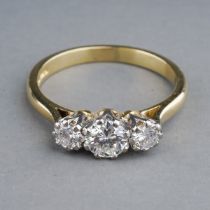 An 18ct yellow gold and diamond three-stone ring, the centre round brilliant-cut diamond approx 0.