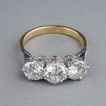 A yellow gold and diamond three-stone ring, set with round brilliant-cut diamonds, centre stone