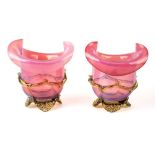 A pair of Victorian pink and green vaseline glass vases, approx. 14.5cm high.
